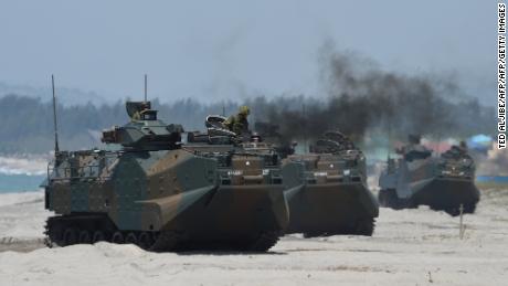 Japanese Ground Self Defense Forces&#39; amphibious assault vehicles hit the beach during an amphibious landing exercise in the Philippines in 2018.
