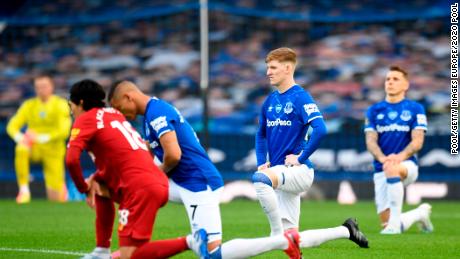 Players and officials take a knee in support of the Black Lives Matter movement  before the Merseyside derby between Everton and Liverpool at Goodison Park. 