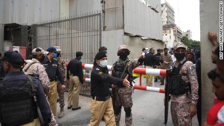 Security personnel gather at the main entrance of the Pakistan Stock Exchange building in Karachi on June 29, 2020.