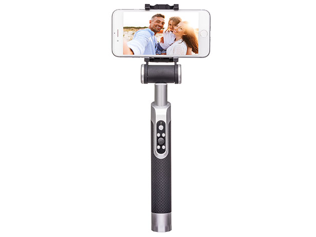 A selfie stick showing a photo on a camera of three people smiling
