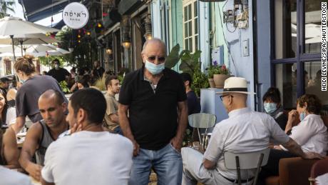 A man wearing a protective mask in a crowded restaurant in Jaffa, Israel, on May 29.