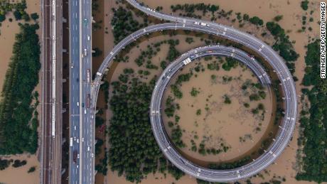 This aerial view shows a bridge leading to the inundated Tianxingzhou island in Wuhan in China&#39;s central Hubei province on July 13.