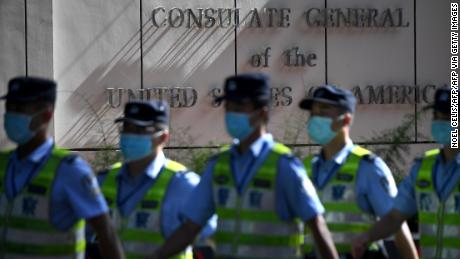 Policemen march in front of the US consulate in Chengdu, southwestern China&#39;s Sichuan province, on July 26.
