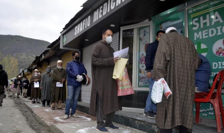 Baramulla: People strictly practising social distancing while they queue up to buy medicines outside a medical store during 21-day long nationwide lockdown imposed as a precautionary measure to contain the spread of COVID-19, in Jammu and Kashmir's Baramu