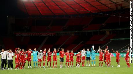 Bayern players celebrate winning the German Cup in a totally empty Olympiastadion.