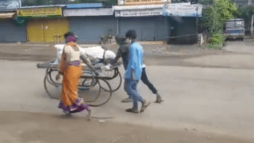 Wife pushes dead husband's body on a cart