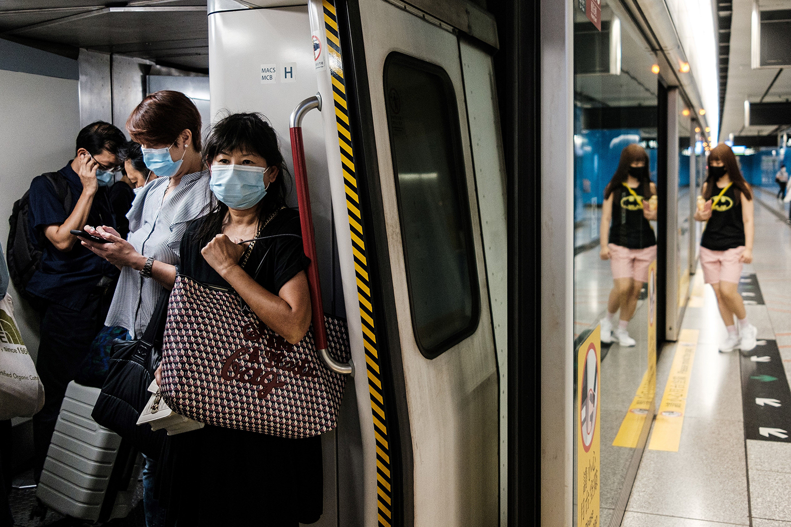 Commuters wear face masks on a metro train in Hong Kong on July 15.