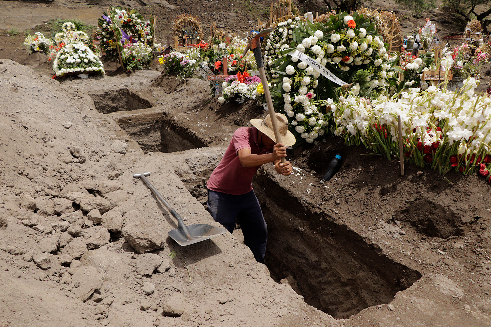 A man digs graves in the Xico-Chalco Civil Pantheon, State of Mexico, on June 26.