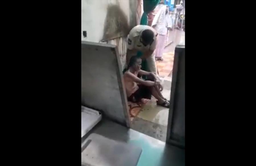 Telangana police giving a bath to elderly man