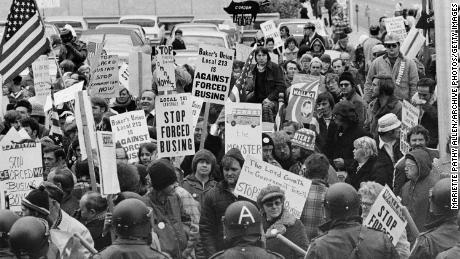 Demonstrators carry signs against forced school busing outside a convention of Democratic leaders in Louisville, Kentucky, on November 23, 1975.