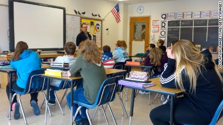 A principal talks to 8th-graders about school safety in Wellsville, New York. Many public schools in the US remain largely segregated.
