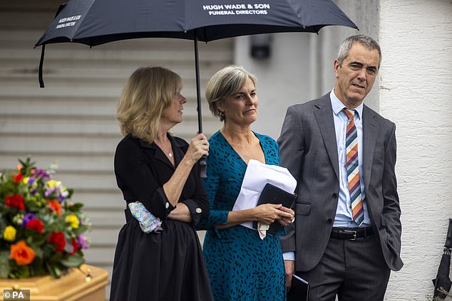 Nesbitt pictured with his sisters Kathryn, left, and Andrea, centre, as they stand together outside the family home in Coleraine, Northern Ireland, as prayers are being said