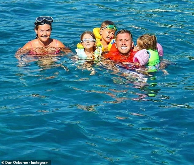 Good times: Dan shared a snap of the family as they swan in the ocean during their stay in the Greek islands