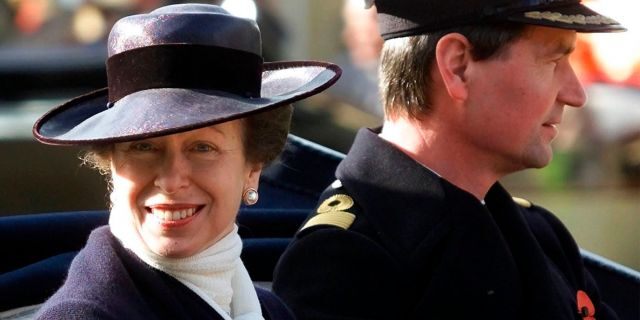 FILE - In this Nov. 6, 2001 file photo, Britain's Princess Anne with her husband Commander Tim Lawrence ride in a ceremonial carriage through Windsor town centre, where they were guests of Queen Elizabeth II at Windsor Castle to welcome King Abdullah and Queen Rania of Jordan on their state visit to England. (AP Photo/Dave Caulkin/File)