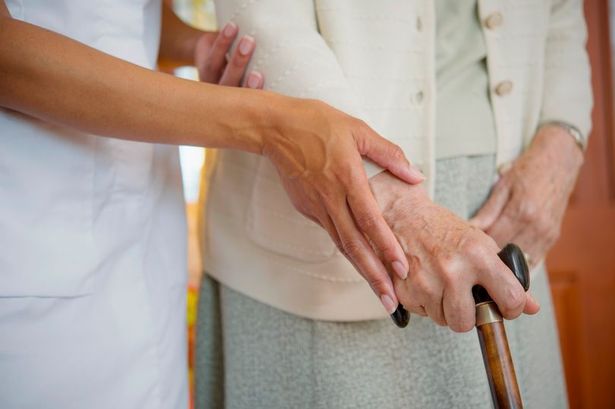 Nursing home patient being helped