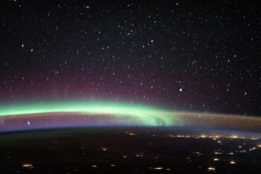 Two of Earth’s Most Colorful Atmospheric Phenomena Meet in Stunning Photo From Space Station