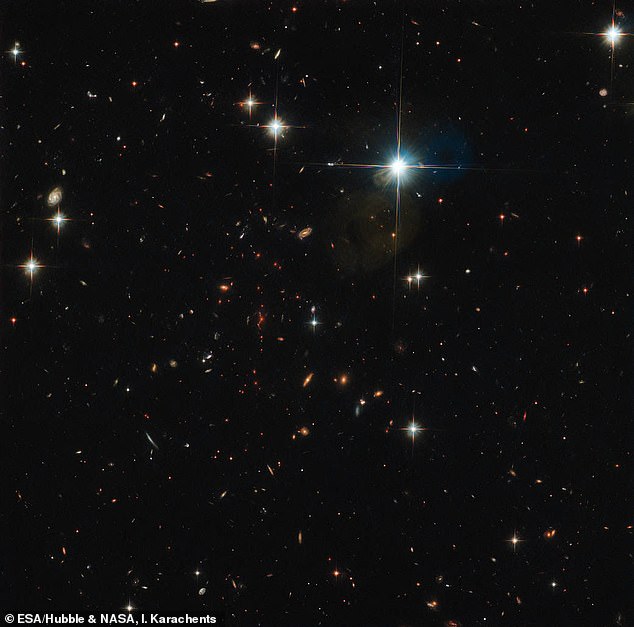 This image from Hubble shows a galaxy cluster - researchers used data from a collection of similar galaxies to estimate the total mass of the known universe.