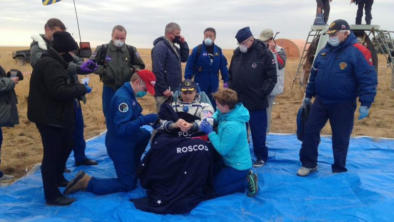 The trio, who had been on the space station for six months, return safely to Earth