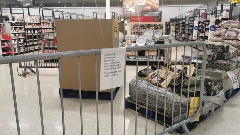 Products including cups and plates can be seen behind a barrier at Tesco in Penguin Green