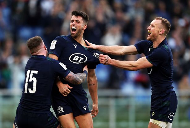 Adam Hastings (center) of Scotland celebrates a goal with Stuart Hogg (left)