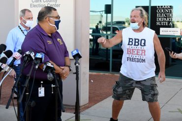 A protester interrupts a news conference by Clark County Registrar Joe Gloria (L) discussing ballot counting at the Clark County Election Department on November 4, 2020 in North Las Vegas, Nevada. Donald Trump and Joe Biden are in a tight race in the battleground state after yesterday's election.  (Photo by Ethan Miller/Getty Images)