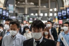 Japan extends virus emergency to 3 municipalities