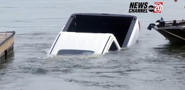 The pickup truck sinks into the lake during a live news link