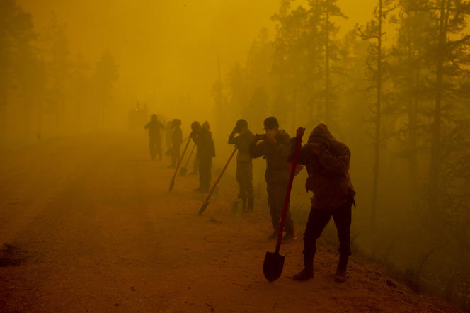 August 7, 2021 Volunteers fighting a fire near the village of Quoreliak in Russia.