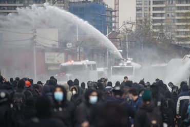 Police in riot gear storm a rally in Chile on Friday, marking the 48th anniversary of the coup.