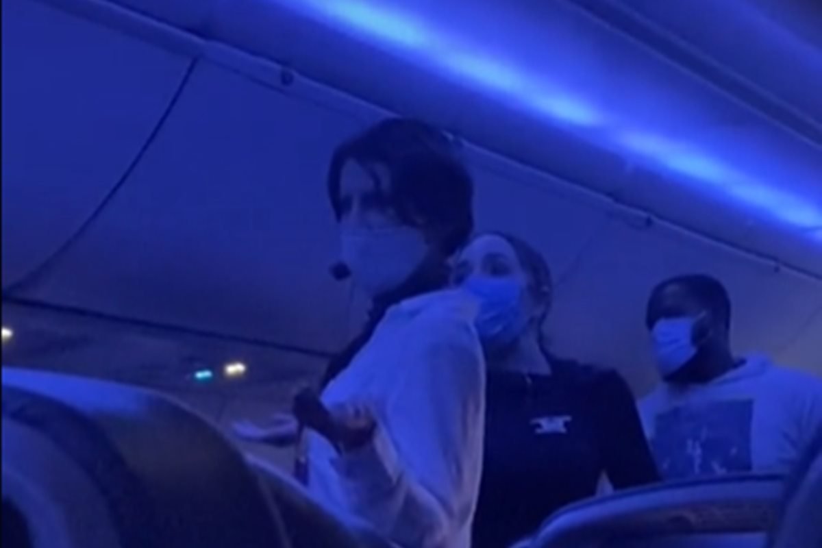 The woman was stopped on the plane while using a microphone to explain Kovid's 
