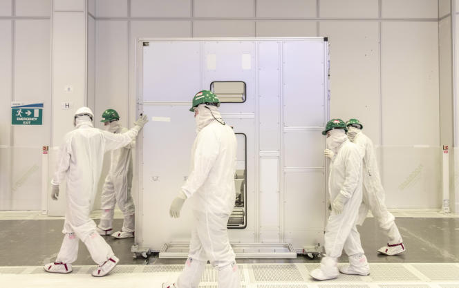 An Intel team carries a chip-making machine to the company's Irish factory on January 12, 2022.