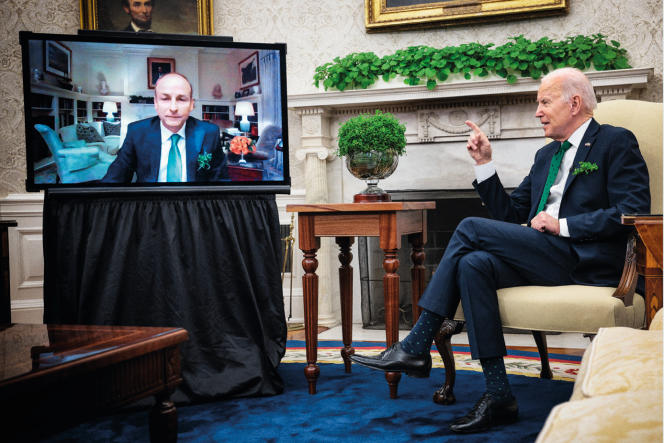 US President Joe Biden speaks via video conference with Irish Prime Minister Michael at the White House Oval Office in Washington on March 17, 2022, St. Patrick's Day.