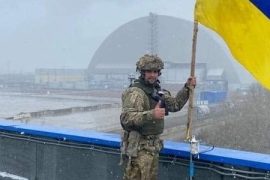 Soldier poses with the Ukrainian flag at Chernobyl