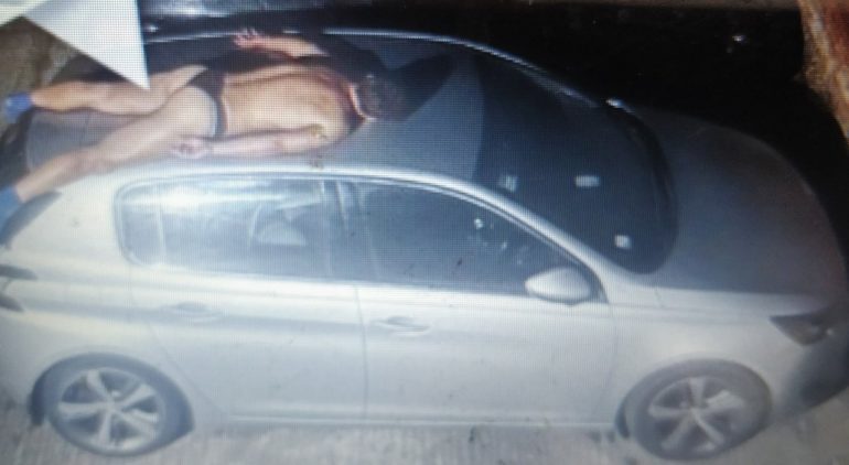 Man in underwear sleeps on top of car, not hidden by home cameras
