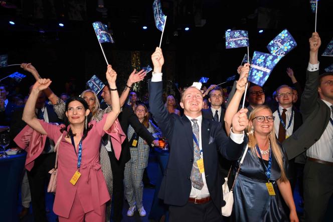 Supporters of the Democrats of Sweden party celebrate the partial results of the parliamentary election in Nacka, near Stockholm, on September 11, 2022, marking the best result in their history.